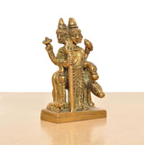 Brass Trimurti idol, three-face detail, seated pose, staff in hand, 4.5 in