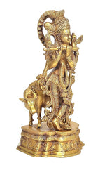 Brass Lord Krishna statue, side view on decorated pedestal, holding star-tipped accessory