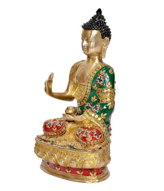 Gold brass meditating Buddha statue, green robe, holding bowl; red patterned base