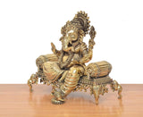 Brass Ganesha idol side view, seated pose on ornate singhasan platform