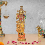 Brass Radha Rani idol with colorful meenakari detailing, standing on pedestal.