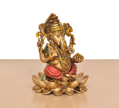 Ganesh resin figurine side view, seated on lotus with red robe and jeweled details