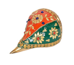 Brass shankh home decor, close view of red and green painted floral pattern
