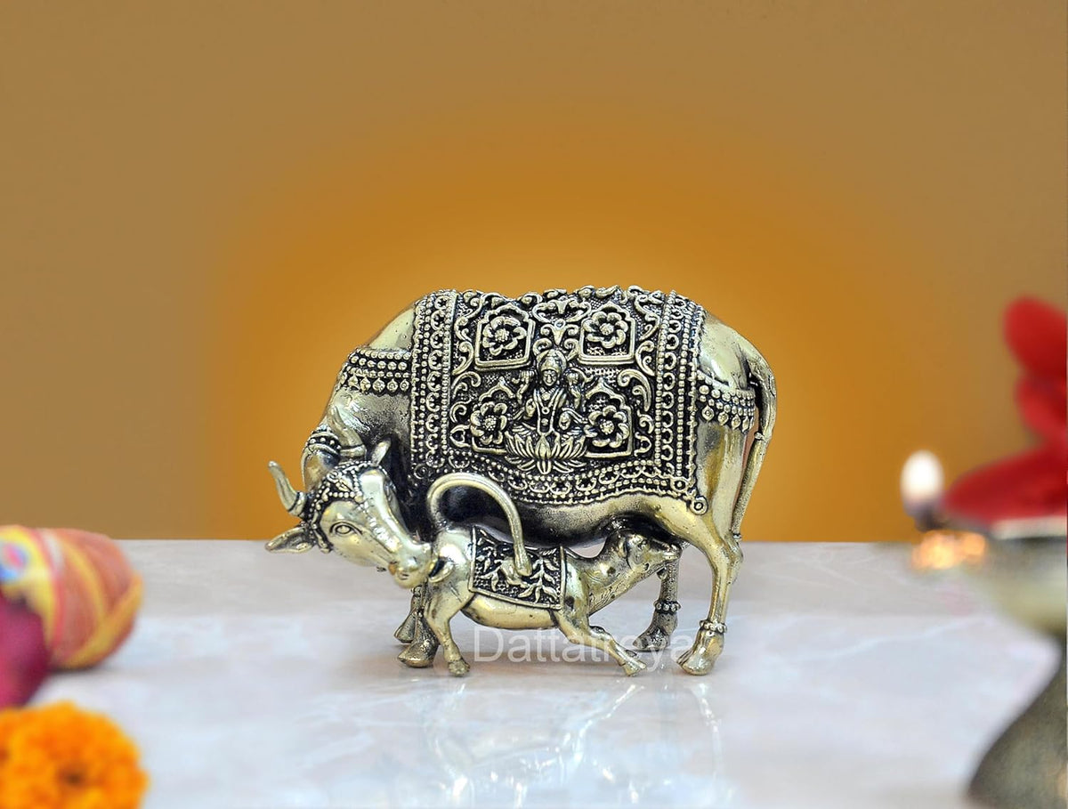 Brass cow with calf figurine, ornate etched detailing on body and legs