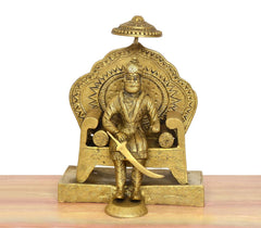 Brass Maharaja Agrasen idol: seated figure on ornate pedestal with crown and shield