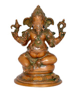 Brass Ganesha statue front view, detailed crown, four arms holding ritual items
