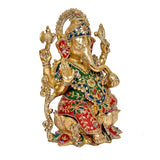 Brass Ganpati idol on lotus base, 12 in, angled view of painted robe and detailed arms