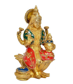 Lakshmi brass deity figurine front-left, red and green attire with ornate jewelry