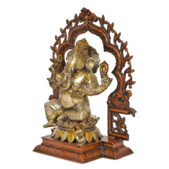 Brass Ganesha idol in profile, seated with raised right hand and carved arch