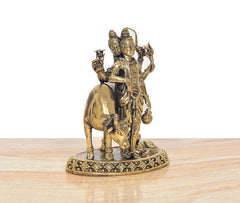 Brass Dattatreya murti angled view, elephant support, intricate ornaments on round base