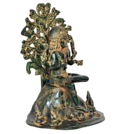 Brass Dakshinamurti Shiva statue side view, green-gold patina and ornate canopy