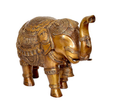Brass elephant figurine side view, curled tail and detailed engraved patterns
