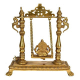 Brass Ganesha swing idol with carved back arch, two finial posts, hanging chains