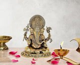 Brass Ganesha idol seated, ornate crown and detailed pedestal base, 7 inch height