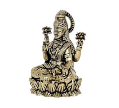 Lakshmi brass idol, angled view, crowned head and four raised hands, seated on lotus