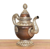 Brass teapot showpiece with dark bronze body, side curved handle, and ornate lid finial