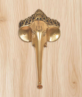 Golden brass Ganesha face door handle with engraved head and fan-like side plates