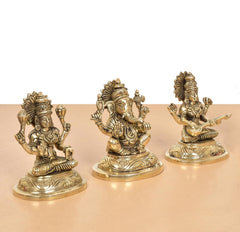 Brass Lakshmi Ganesha Saraswati Idol set, three gold-tone seated figures with raised arms
