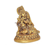 Brass Radha-Krishna statue seated on asan, profile view with raised garland beads and ornaments