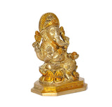 Brass Ganesha idol, three-quarter view, crown and hands posed on lap, on base