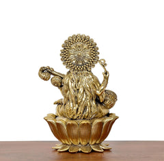 Brass Maa Saraswati statue from behind, holding veena, seated on lotus base