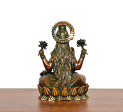 Lakshmi brass idol from back, long hair detail around raised halo and lotus base