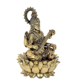 Brass Saraswati statue seated on lotus with veena, raised hand and halo
