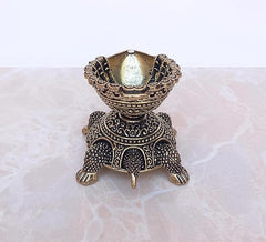 Brass tortoise diya oil lamp, front view showing engraved bowl interior