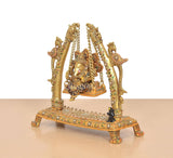 Side view brass swinging jhula idol with Ganesha and decorated pillar supports