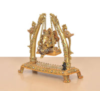 Side view brass swinging jhula idol with Ganesha and decorated pillar supports