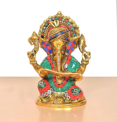 Front view metal Ganesha idol with jeweled crown, colorful clothing, raised hands and scroll