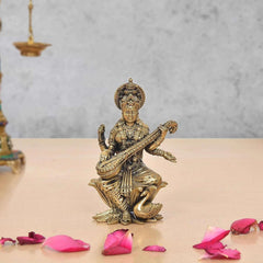 Brass Maa Saraswati statue seated on lotus, holding veena, school-bag size 4 inch