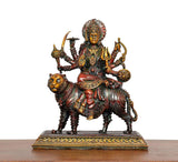 Durga Maa brass statue on tiger with fan-like crown, multiple arms holding symbols