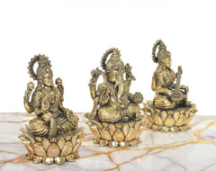 Brass Lakshmi, Ganesha and Saraswati idols from rear angle with detailed crowns