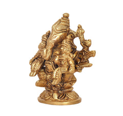 Brass Ganesha idol with Riddhi and Siddhi, angled view with detailed faces