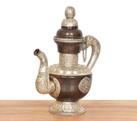 Himalayan brass teapot with dark brown body, engraved round medallion, and domed lid