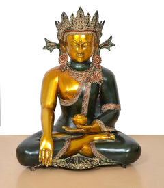 Seated Buddha statue with golden face and bhumisparsha mudra, detailed ceremonial robe