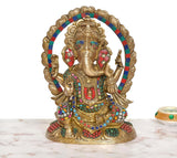 Brass Ganesha figurine with multicolor gemstones, round halo, and ornate base