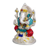Front view brass Ganesha idol with gold crown, turquoise ornaments, red lower cloth, arms apart