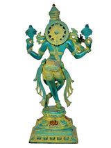 Rear view Krishna playing flute statue, turquoise-green figure with gold halo and arms