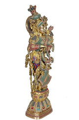 Brass Radha idol with raised hand, gold ornaments, green-red patterned dress