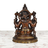 Brass Ganpati Bappa murti, rear view with wheel-like halo and four hands