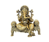 Brass Ganesha idol seated on decorated base, front view, 4 inch height