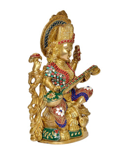 Brass Saraswati statue profile view, goddess holding flute, detailed face and headdress