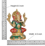 Brass Ganesha idol, height 6.5 in: green robe with floral motifs, red base, gold arms