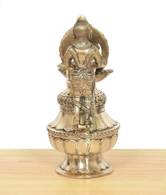 Brass oil lamp with back view deity and rounded flame bowl pedestal