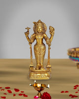 Golden brass Dhanvantri idol statue, four-armed with lamp-like stand