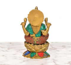 Brass Lakshmi idol back view, multicolored outfit and beaded jewelry on lotus base