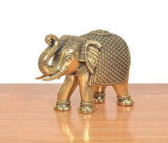 Bronze elephant figurine side view, intricate grid pattern on back and beaded trim