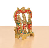 Brass Ram Darbar idol with three seated, colorful painted figures and arched frame